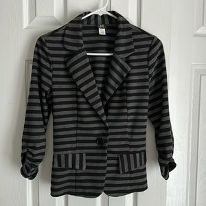 Women’s black and grey striped blazer in size Medium in very good condition.